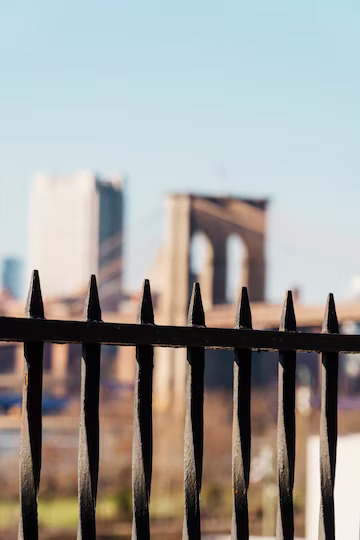 brooklyn-bridge-through-black-fence_23-2148184332